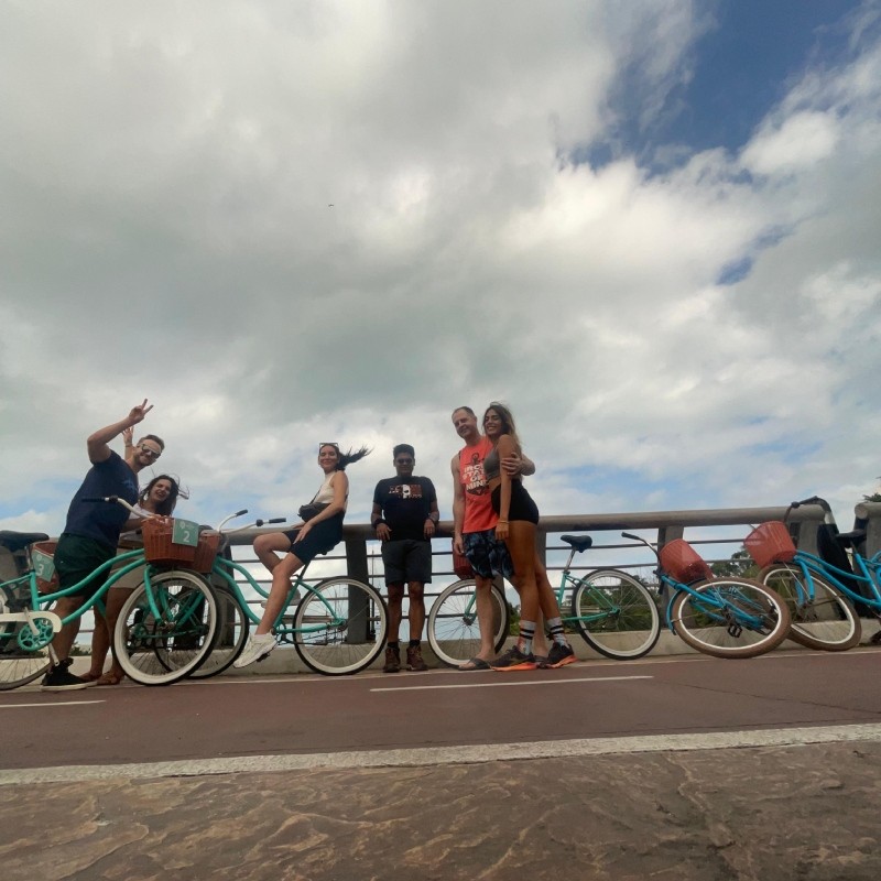 Mayan Monkey guests posing with beach cruiser bikes on a bike tour