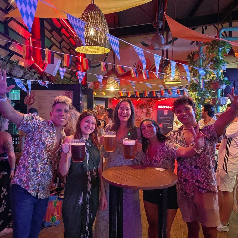 Mayan Monkey guests cheering with beer mugs at an Oktoberfest party