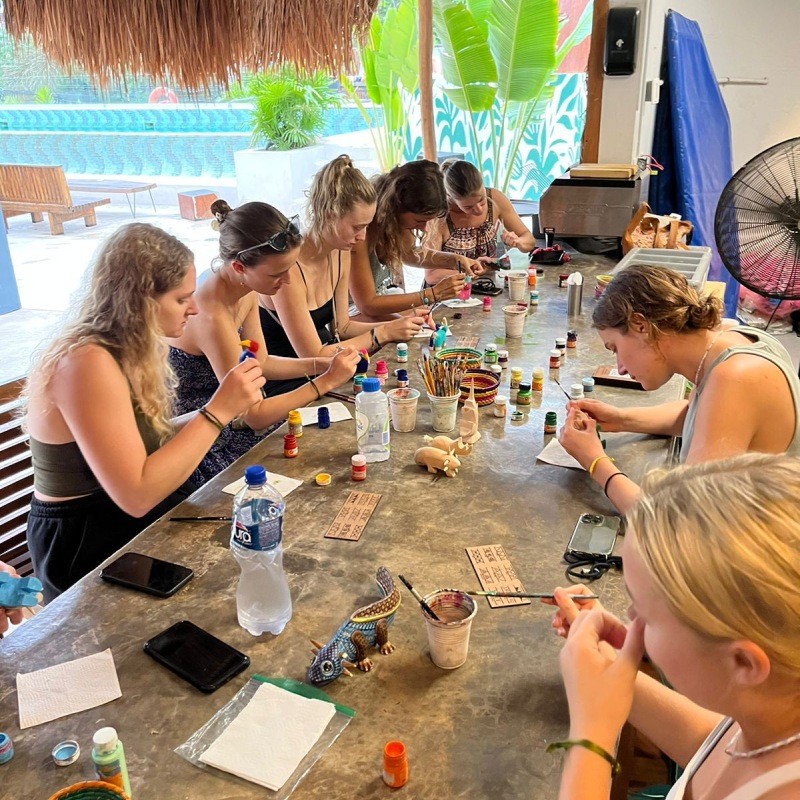 Guests painting alebrijes at a Mayan Monkey craft workshop