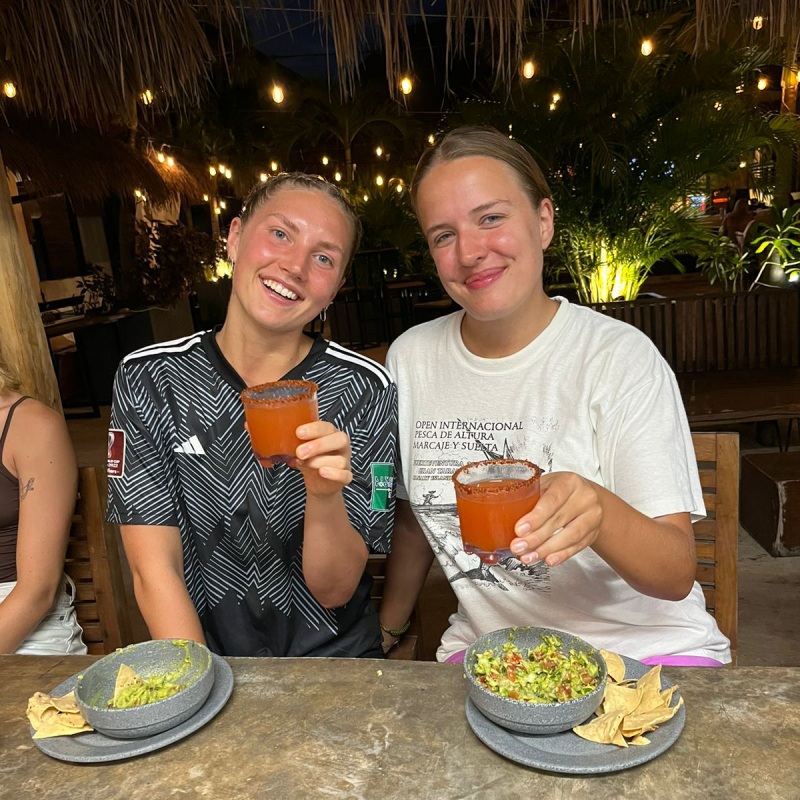 Guests enjoying micheladas and guacamole at a Mayan Monkey dinner